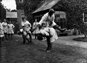 Women's Land Army Collection: Members of the First World War Womens Land Army playing leap frog. Tregavethan Farm, Truro, Cornwall