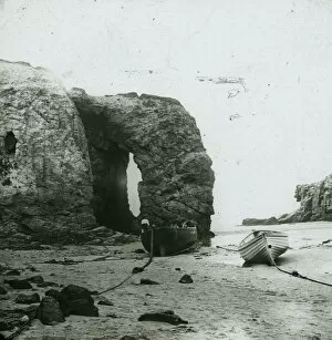 Images Dated 2nd January 2016: Perranporth Arch Rock, with boats on the beach, Cornwall. Around 1925