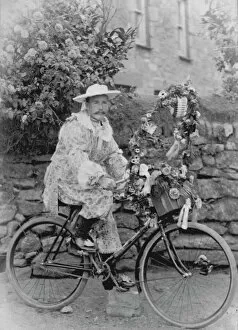 Images Dated 29th October 2019: Samuel John Govier posed in fancy dress on his bicycle, locality unknown but somewhere in West