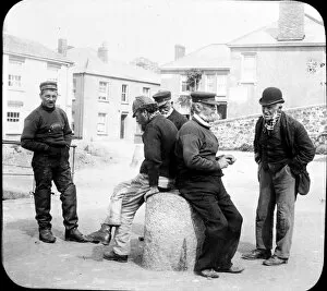Flushing Collection: Seamen chat on the quayside, Flushing, Cornwall. 1890s