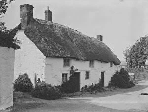 Mullion Collection: Thatched cottages in Mullion village, Cornwall. 1908