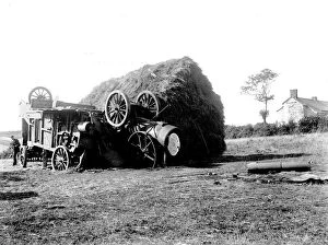 Agriculture Collection: Threshing machine in collision with a hayrick. Possibly in St Stephen in Brannel, Cornwall